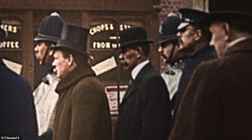 The remarkable Newsreel film of the then Home Secretary (pictured in the brown coat) standing alongside armed police as they surround a blazing Latvian gang