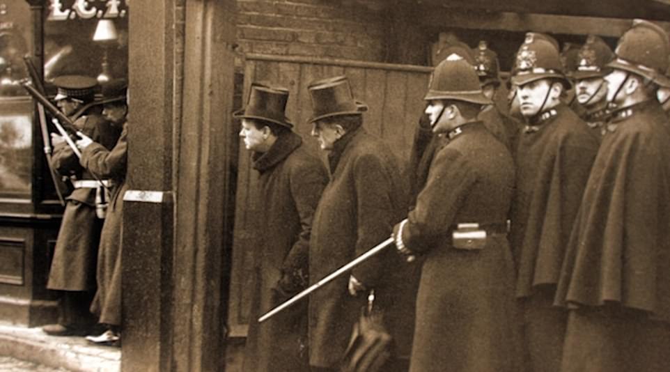 Churchill watched from the sidelines as members of the police and Scots Guards exchanged fire with the two men holed up inside the building. In one clip he can be seen peering around a corner as the gun battle waged on