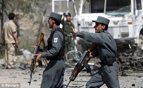 Afghan policemen secure the scene of a blast in Kabul today. An apparent suicide car bomber hit a Nato military vehicle
