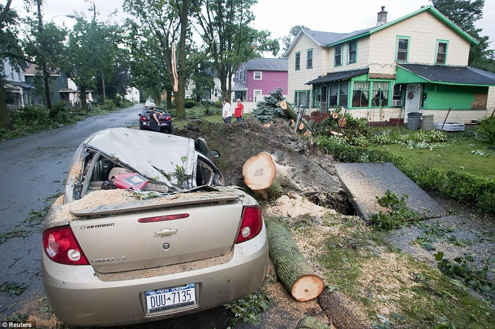 Crushed: A crushed automobile is seen the morning after the town was hit by a tornado in Elmira, New York July 27, 2012