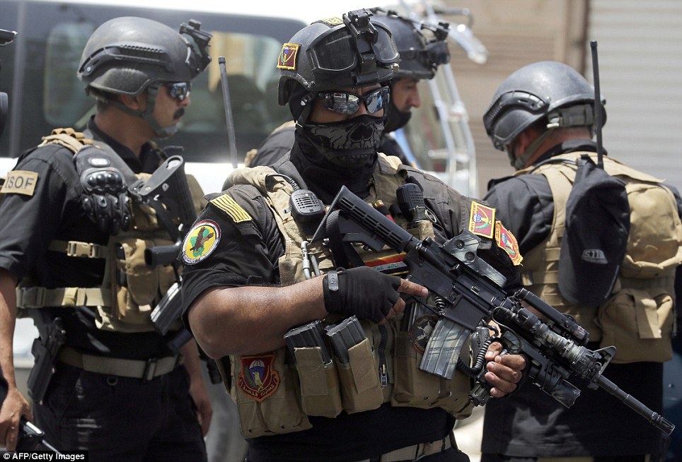 Armed and ready: Iraqi special forces secure a district in Baghdad as Prime Minister Nouri al-Maliki claimed the government had 