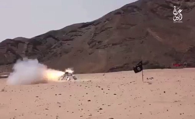 Fanatic: A remotely fired rocket launcher is fired at the men in the desert location as the black flag used by jihadi groups including ISIS stands in the foreground