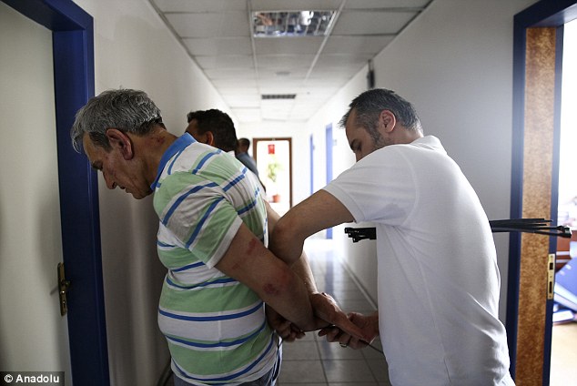 The detainees, including Ozturk were rounded up and had their hands bound by police with cable ties 