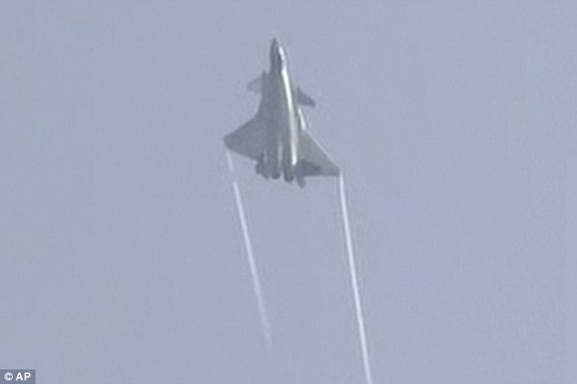 In this image made from video, the J-20 stealth fighter pulls a sharp incline to a a crowd of spectators and dignitaries at the Zhuhai airshow